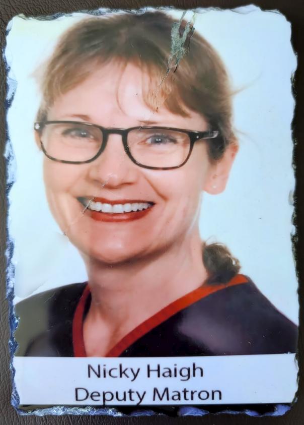 Nicky's hospital identity photograph, printed on slate, captioned ‘Nicky Haigh, Deputy Matron’